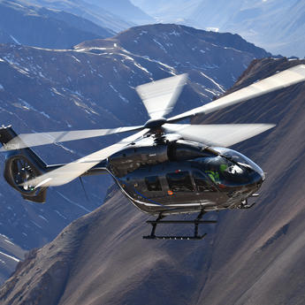 Five bladed H145 flying over mountains